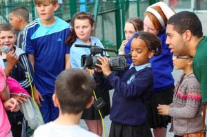 photo of young people using a video camera