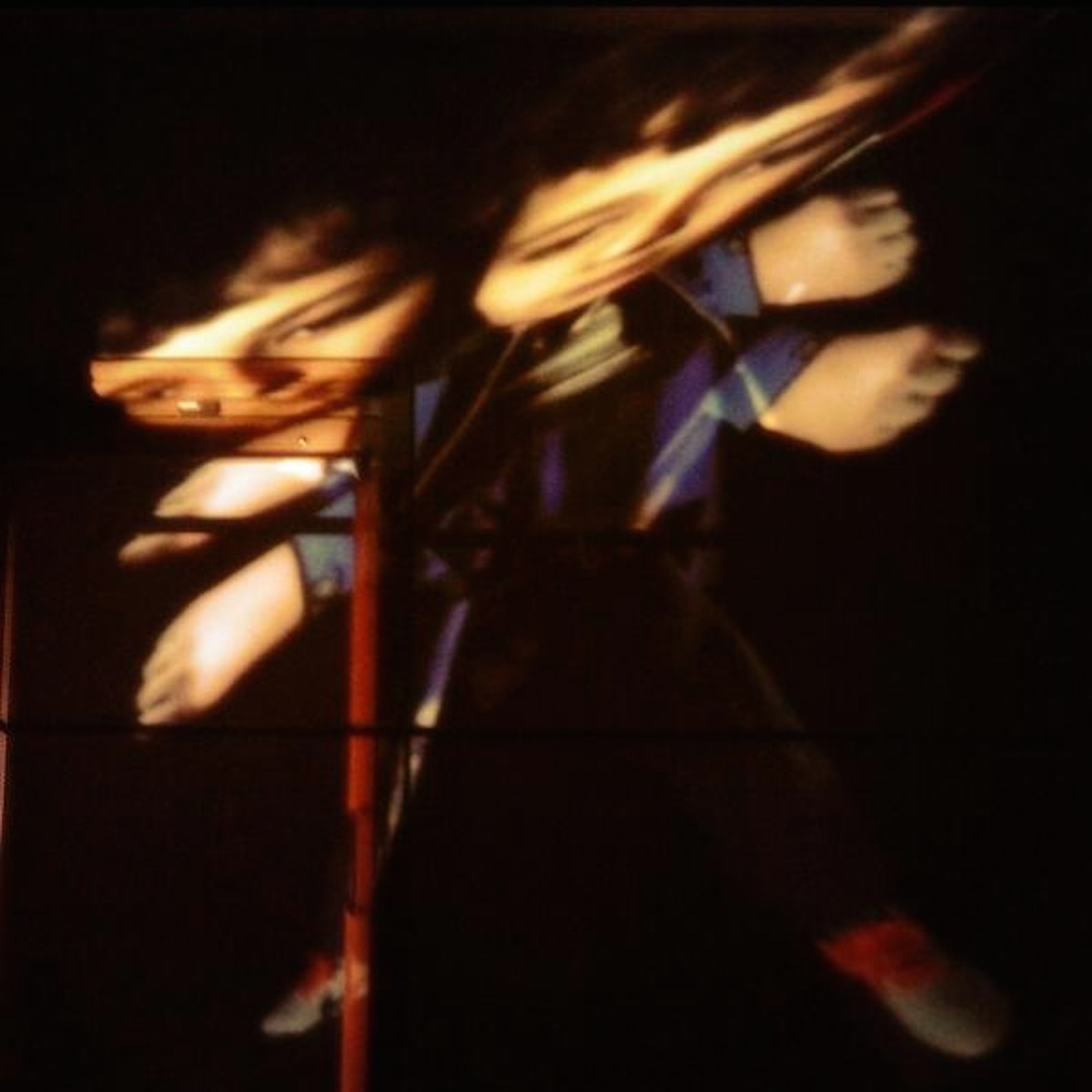 photo of a young person being projected and distorted on to some boxes