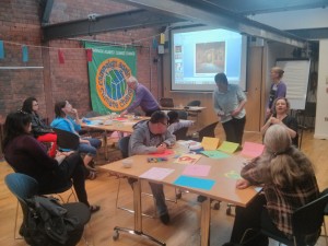 Image of people sat around tables part-taking in a workshop