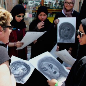 Photo of Rachel with a group of women holding their portraits.