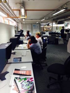 Image of a computer room with people working