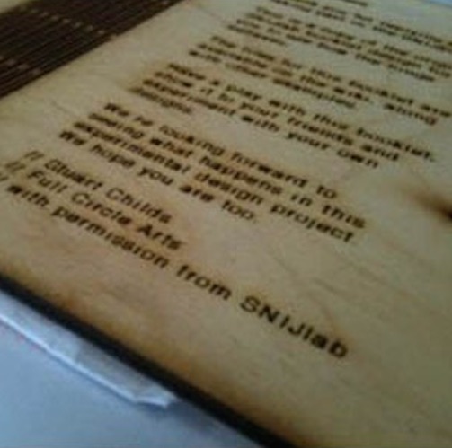 image of a plywood note book laser printed with details about the project